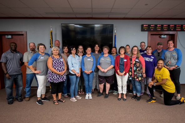 Members of Cannon Air Force Base and its local schools pose for a photo at the end of Teachers Understanding Deployment Operations at Cannon Air Force Base, N.M, Sept. 14, 2019. TUDOS is a program made to educate teachers and faculty of local schools about what military life is like and how it can affect the children of military members. (U.S. Air Force photo by Senior Airman Vernon R. Walter III)