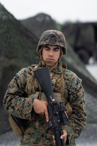 U.S. Marine Lance Cpl. Gabriel Marrero, a fire directional control specialist with Headquarters Battery, 12th Marine Regiment, 3rd Marine Division, stands security during Thunder Field Training Exercise on Camp Hansen, Okinawa, Japan, Sept. 18, 2019. The purpose of the exercise is to rehearse setting up an expeditionary combat operations center and refine procedures for doing so. Marrero is a native of Atlantic City, N.J. (U.S. Marine Corps photo by Pfc. Jamal Norris)