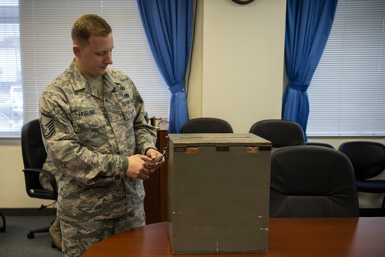 Master Sgt. John Freeling, 374th Contracting Squadron contracting officer, opens a bidding lockbox on Sept. 13, 2019, at Yokota Air Base, Japan.