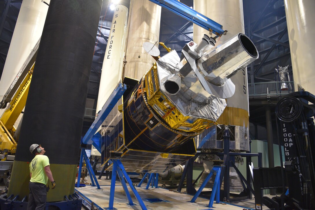 Workers move satellite.