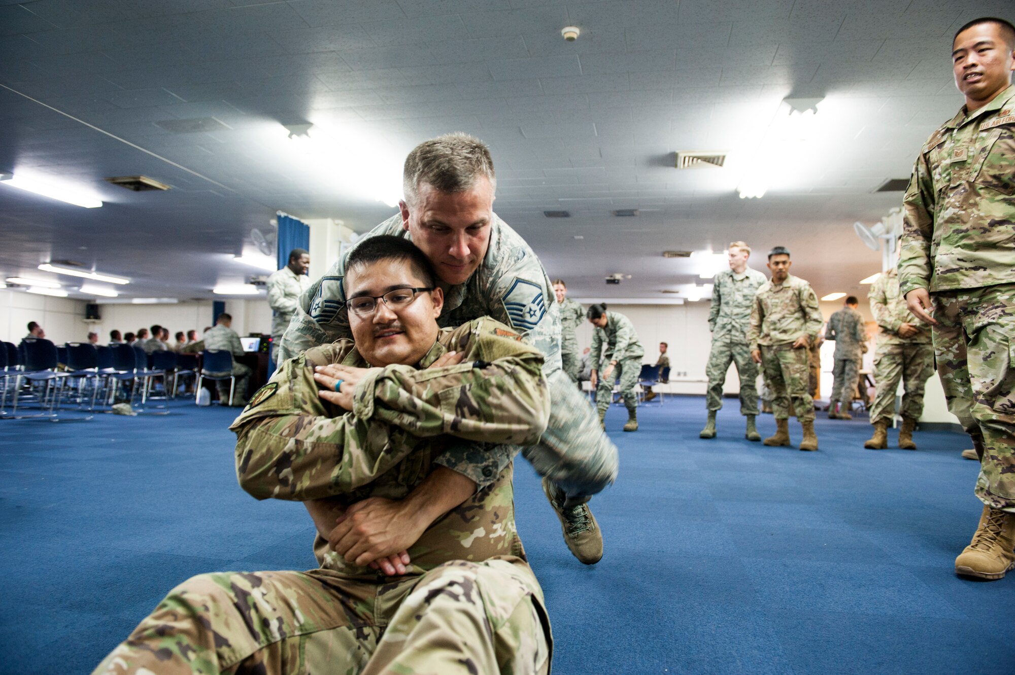 Participants demonstrate fore-and-aft carrying procedures during Ability to Survive and Operate training at Kadena Air Base, Japan, Sept. 12, 2019. Self-Aid and Buddy Care, an essential part of survival for Airmen, is basic medical care given during loss of life or limb situations until more advanced medical providers arrive. (U.S. Air Force photo by Naoto Anazawa)