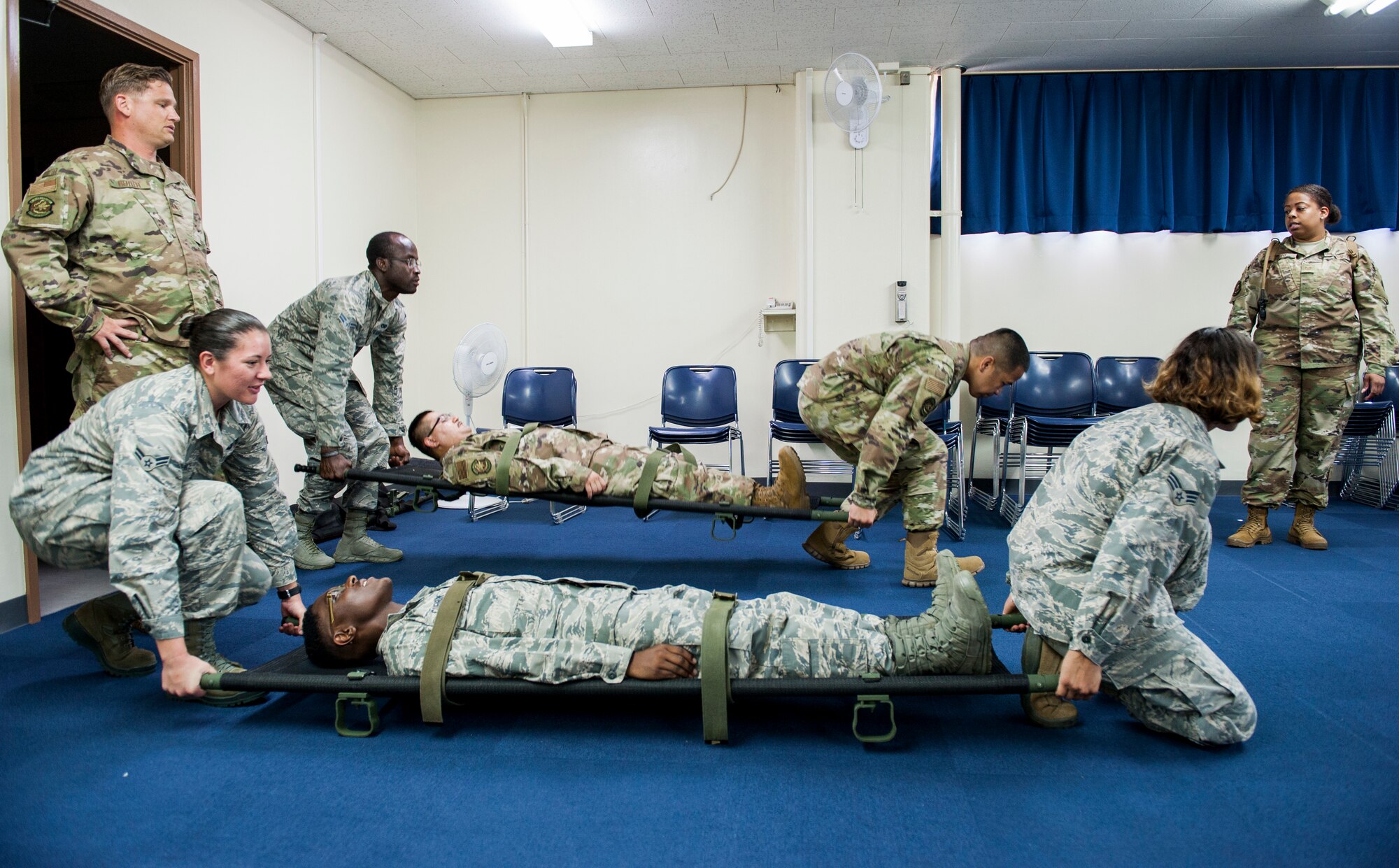 Airmen practice litter carry techniques during Ability to Survive and Operate training at Kadena Air Base, Japan, Sept. 12, 2019. More than 300 Airmen from the 18th Logistics Readiness Squadron participated in the event that teaches proficiency in response and recovery in the event of a chemical, biological, radiologic or nuclear threats. (U.S. Air Force photo by Naoto Anazawa)