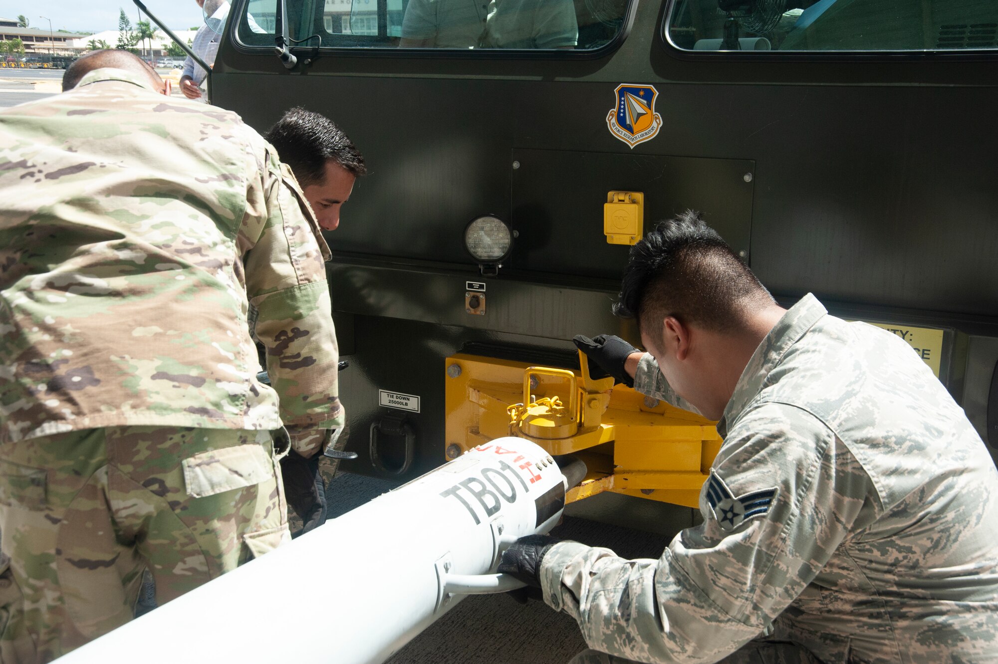 154th Maintenance Squadron crew chiefs hook up a tow bar to a hydrogen fuel cell powered U-30 Aircraft Tow Tractor, July 18, 2019, Joint Base Pearl Harbor-Hickam, Hawaii.