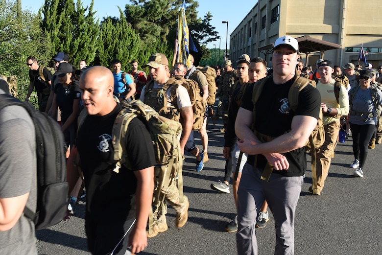 Members of the 8th Fighter Wing walk during the prisoners of war and missing in action 10-kilometer ruck march at Kunsan Air Base, Republic of Korea, Sept. 16, 2019. Between Sept. 16 and 20, the 8th FW hosted several events including a flag raising, candlelight vigil and a 24 hour run. (U.S. Air Force photo by Staff Sgt. Joshua Edwards)