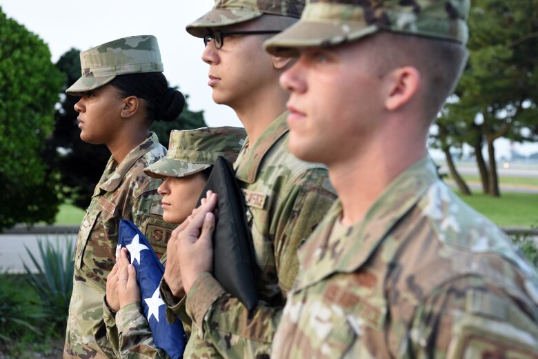 Members of the 8th Fighter Wing Honor Guard wait to raise the American flag and the prisoners of war and missing in action flag during the POW/MIA opening ceremony at Kunsan Air Base, Republic of Korea, Sept. 16, 2019. The 8th Fighter Wing held several events throughout the week to honor the men and woman who have not returned home. (U.S. Air Force photo by Staff Sgt. Joshua Edwards)