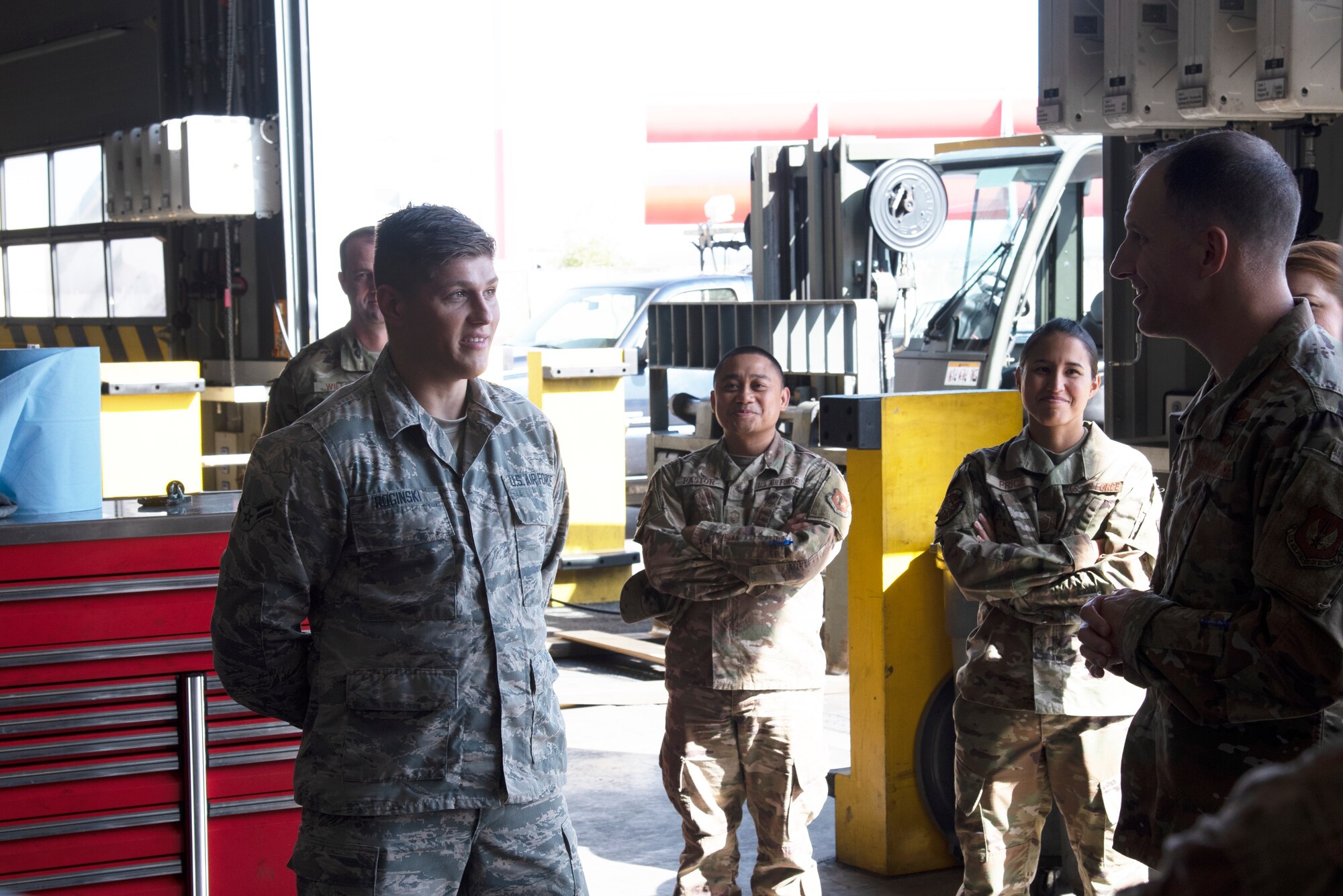 U.S. Air Force Col. Matthew S. Husemann, right, 86th Airlift Wing vice commander, recognizes Airman 1st Class Kamil Roginski, left, 86th Vehicle Readiness Squadron materiel handling equipment journeyman, as Airlifter of the Week at Ramstein Air Base, Germany, Sept. 19, 2019.