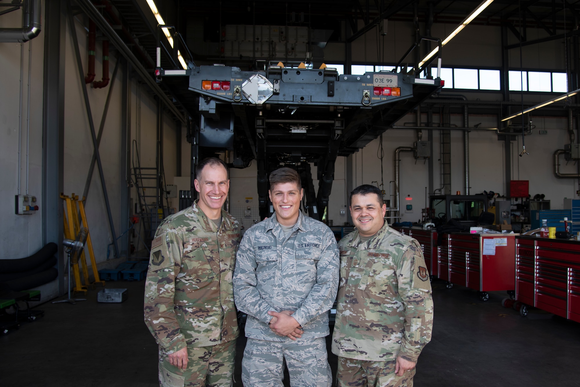 U.S. Air Force Col. Matthew S. Husemann, 86th Airlift Wing vice commander, and Chief Master Sgt. Ernesto J. Rendon, 86th AW command chief, recognize Airman 1st Class Kamil Roginski, 86th Vehicle Readiness Squadron materiel handling equipment journeyman, as Airlifter of the Week at Ramstein Air Base, Germany, Sept. 19, 2019.