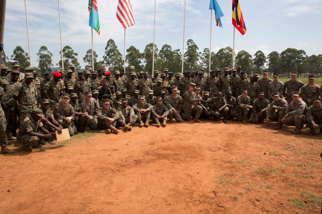 U.S. Marines and Sailors and Uganda People's Defense Force Soldiers pose for a group photo after a closing ceremony at Camp Singo, Uganda, Aug. 29, 2019. Marines and Sailors Special Purpose Marine Air-Ground Task Force-Crisis Response-Africa 19.2, Marine Forces Europe and Africa, have advised the UPDF soldiers on logistics and small unit tactics courses. The courses lasted 16 weeks with Marine advisors providing mentorship and guidance to a cadre of UPDF instructors. (U.S. Marine Corps photo by Staff Sgt. Mark E Morrow Jr.)