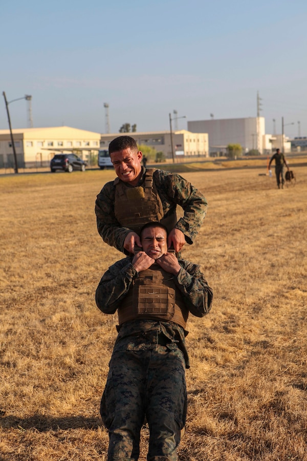 A U.S. Marine with Special Purpose Marine Air-Ground Task Force-Crisis Response-Africa 19.2, Marine Forces Europe and Africa, executes buddy-lifts for combat-conditioning during Marine Corps Martial Arts Instructor Course at Moron Air Base, Spain, Sept. 5, 2019. MAIC is a knowledge-driven course that teaches proper Marine Corps Martial Arts Program techniques and builds the ethical warrior mindset. SPMAGTF-CR-AF is deployed to conduct crisis-response and theater-security operations in Africa and promote regional stability by conducting military-to-military training exercises throughout Europe and Africa. (U.S. Marine Corps photo by Capt. Clay Groover)