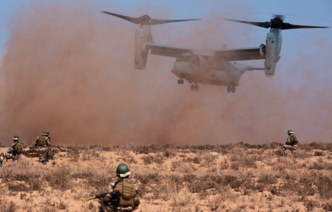 Members of the Royal Moroccan Armed Forces secure a landing zone while a U.S. Marine Corps MV-22B Osprey with Special Purpose Marine Air-Ground Task Force-Crisis Response-Africa 19.2, Marine Forces Europe and Africa, lands in Tifnit, Morocco, during a tactical recovery of aircraft and personnel exercise, Sept. 10, 2019. TRAP is a core function of a crisis-response force and SPMAGTF-CR-AF 19.2 consistently trains to increase TRAP proficiency by rehearsing realistic scenarios. SPMAGTF-CR-AF is deployed to conduct crisis-response and theater-security operations in Africa and promote regional stability by conducting military-to-military training exercises throughout Europe and Africa. (U.S. Marine Corps photo by Cpl. Gumchol Cho)