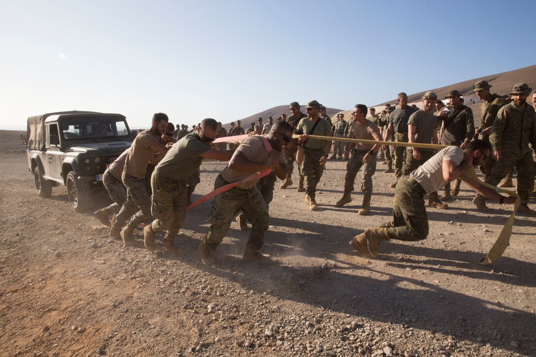 Spanish Soldiers pull a vehicle during a field meet Fuerteventura, Canary Islands, Spain, Sept. 11, 2019. The Soldiers competed against U.S. Marines with Special Purpose Marine Air-Ground Task Force-Crisis Response-Africa 19.2, Marine Forces Europe and Africa, to celebrate the end of their bilateral exercise and increase camaraderie. SPMAGTF-CR-AF is deployed to conduct crisis-response and theater-security operations in Africa and promote regional stability by conducting military-to-military training exercises throughout Europe and Africa. (U.S. Marine Corps photo by Staff Sgt. Mark E Morrow Jr)