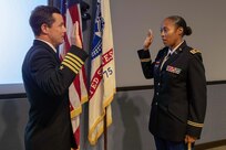 U.S. Navy Capt. Bryan Cochran administers the Oath of Office to U.S. Army Lt. Col. Tiffany Dills during her promotion ceremony at Joint Task Force Civil Support headquarters. The promotion was attended by her family, including her husband U.S. Army Lt. Col. John Dills, who is currently deployed and was able to attend via video teleconference.  (Official DoD photo by Mass Communication Specialist 3rd Class Michael Redd/RELEASED)
