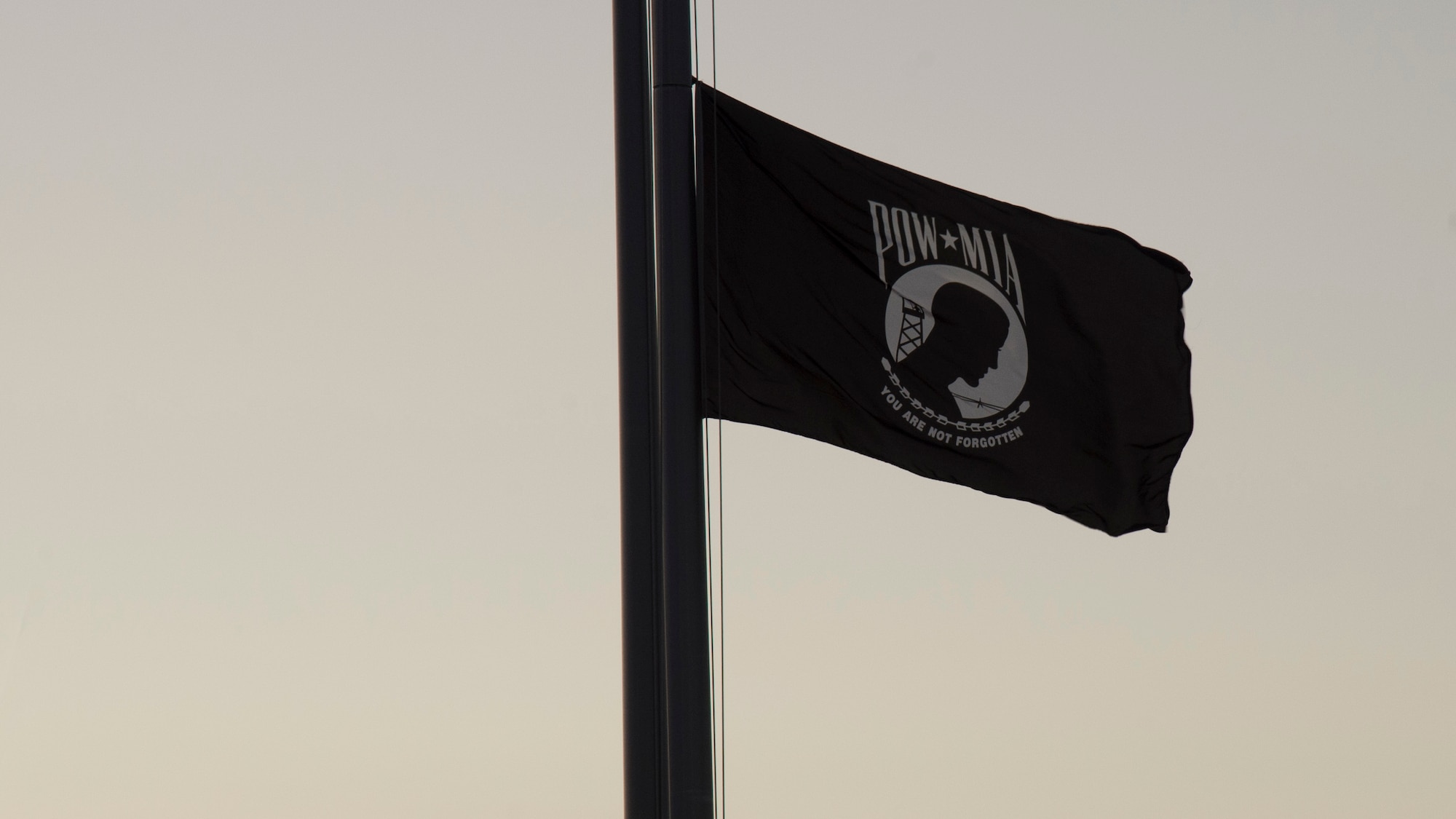 The POW/ MIA Flag waves over MacDill Air Force Base, Sept. 20, 2019. POW/MIA Recognition Day is commemorated nationally on the third Friday of every September in honor of service members who were prisoners of war as well as those missing in action. (U.S. Air Force photo by Airman 1st Class Shannon Bowman)