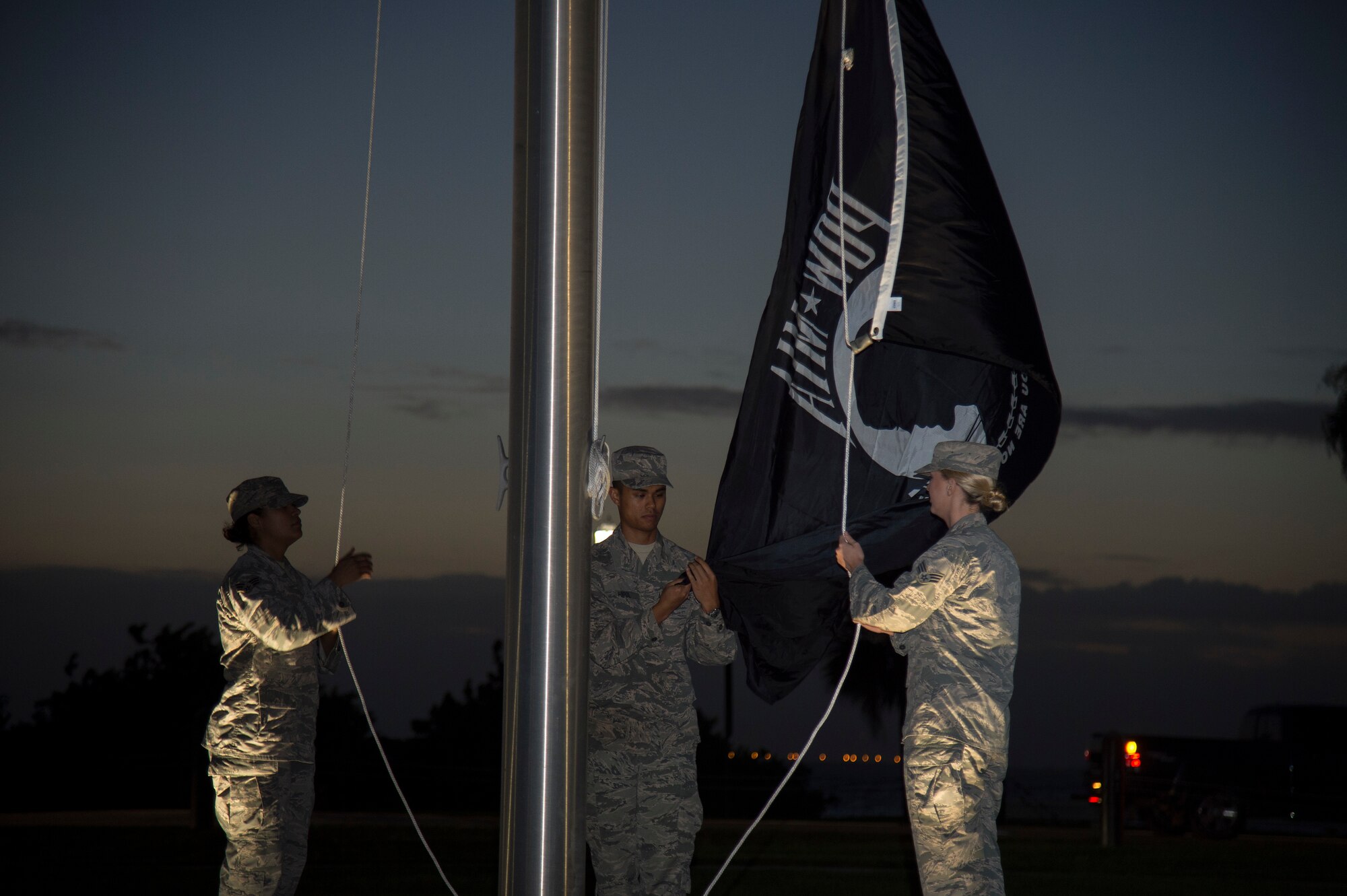 U.S. Air Force Senior Airman Karina Rodriguez (left), Airman 1st Class Dyllan Hipol (center), and Senior Airman Andrea Stutts (right), MacDill Air Force Base honor guardsmen, raise the POW/ MIA Flag Sept. 20, 2019, at MacDill AFB, Fla.  POW/MIA Recognition Day is commemorated nationally on the third Friday of every September in honor of service members who were prisoners of war as well as those are missing in action. (U.S. Air Force photo by Airman 1st Class Shannon Bowman)