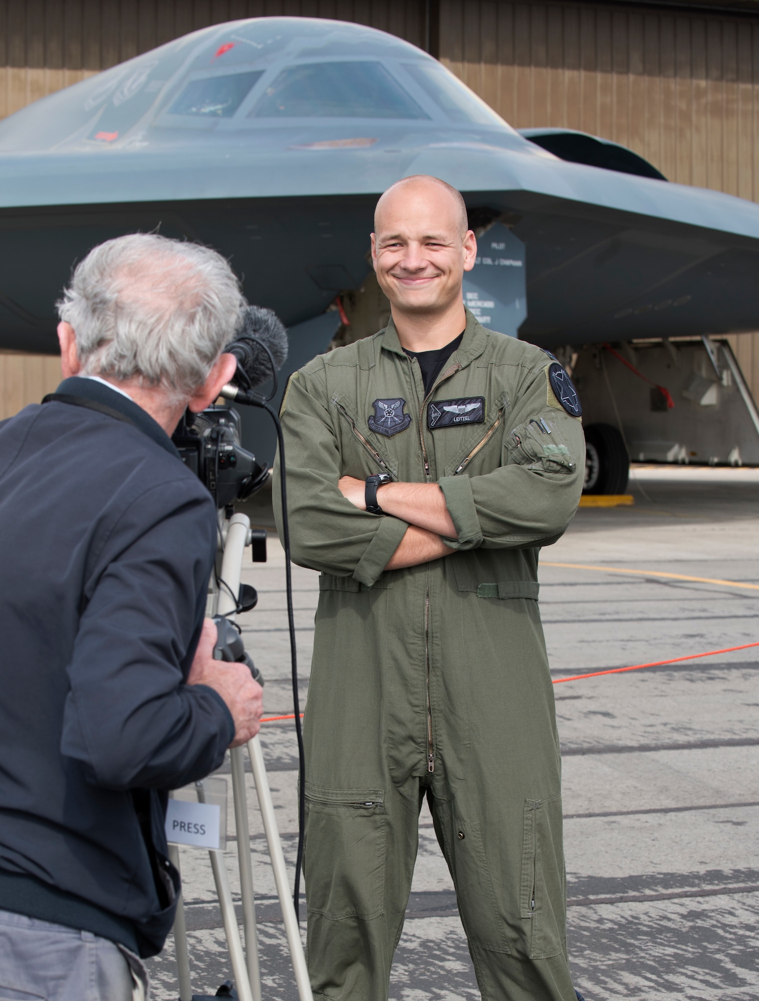 Captain Erik Leitzel, a B-2 Spirit pilot assigned to the 393rd Bomb Squadron at Whiteman Air Force Base, Missouri, stands for an interview with a British journalist on August 30, 2019, at Royal Air Force Fairford, England. Leitzel is a third-generation bomber pilot, following his grandfather and father, two retired Air Force colonels, who also served at or near RAF Fairford during their respective careers. (U.S. Air Force photo by Staff Sergeant Kayla White)