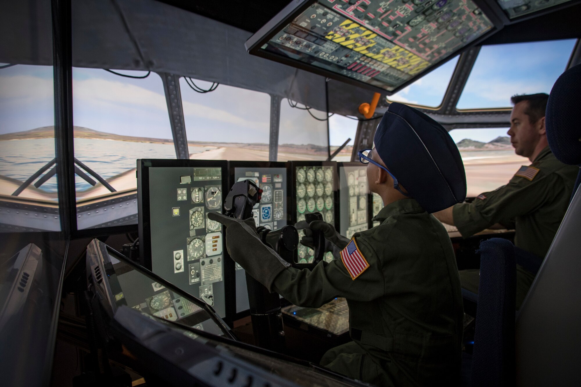 Ayden Houston and Maj. Richard Stocker fly a C-130 Hercules flight simulator