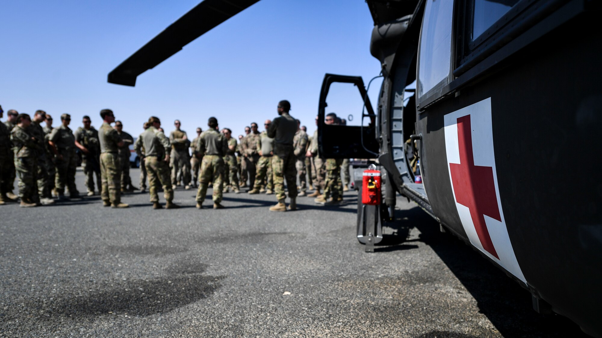 Service members from the U.S. Air Force, Army and Navy  gather for a safety briefing before a K-9 medical evacuation exercise at Ali Al Salem, Kuwait, Sept. 13, 2019. The exercise included veterinarian clinical specialist’s with the 149th Medical Detachment Veterinary Service Support Unit; medical first responders with the 386th Expeditionary Medical Group and more than 15 military working dog teams from various units around the U.S. Central Command area of responsibility. (U.S. Air Force photo by Staff Sgt. Mozer O. Da Cunha)