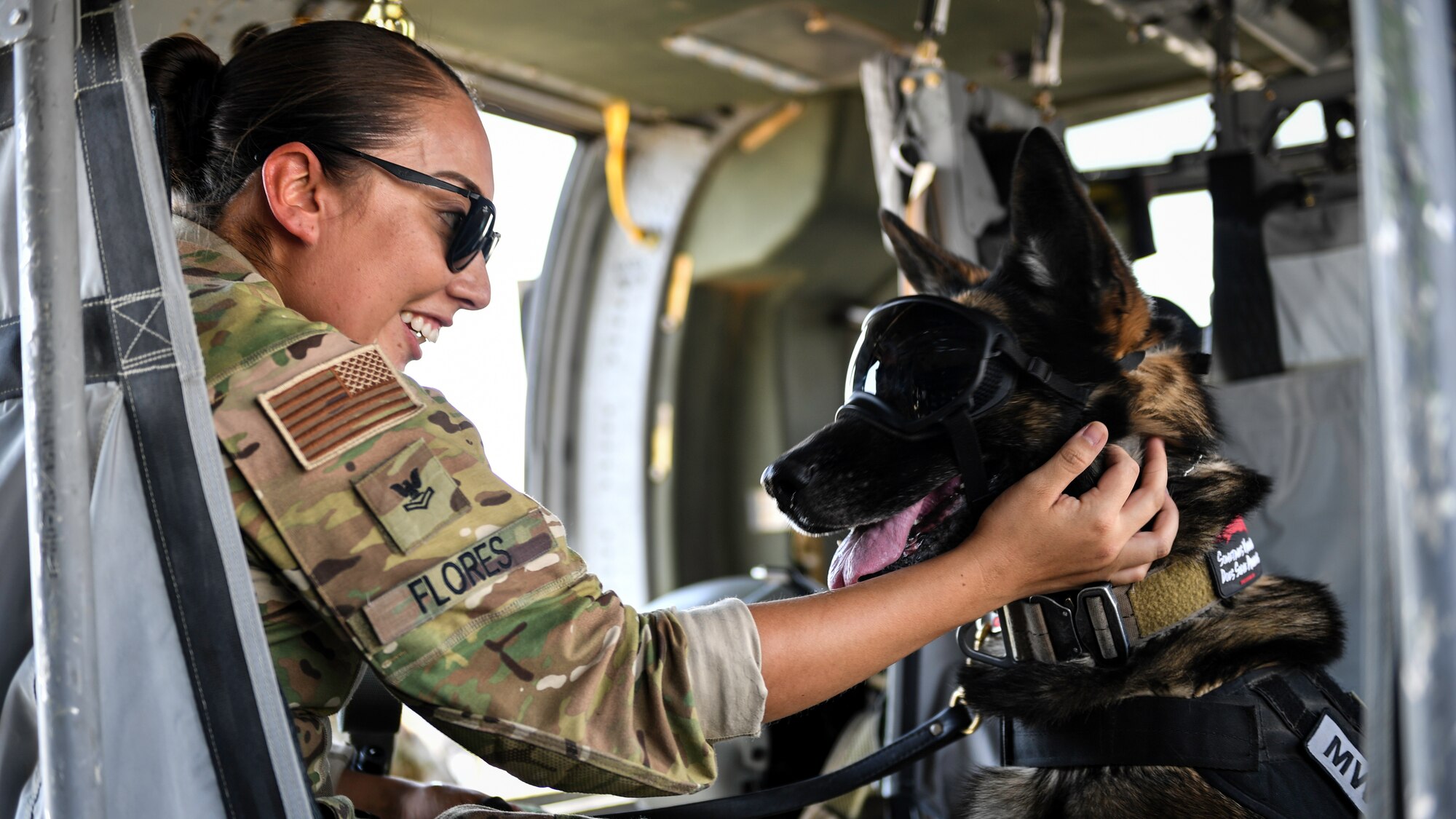 U.S. Navy Master-at-Arms 2nd Class Brianna Flores, Area Support Group Kuwait – Directorate of Emergency Services – K-9 Unit military working dog handler, comforts her military working dog after boarding a UH-60 Black Hawk helicopter at Ali Al Salem Air Base, Kuwait, Sept. 13, 2019. As part of the exercise, U.S. Army veterinary doctors worked with emergency medical responders sharing life-saving measures for MWDs in case of extreme emergencies where veterinary technicians might not be immediately available. (U.S. Air Force photo by Staff Sgt. Mozer O. Da Cunha)