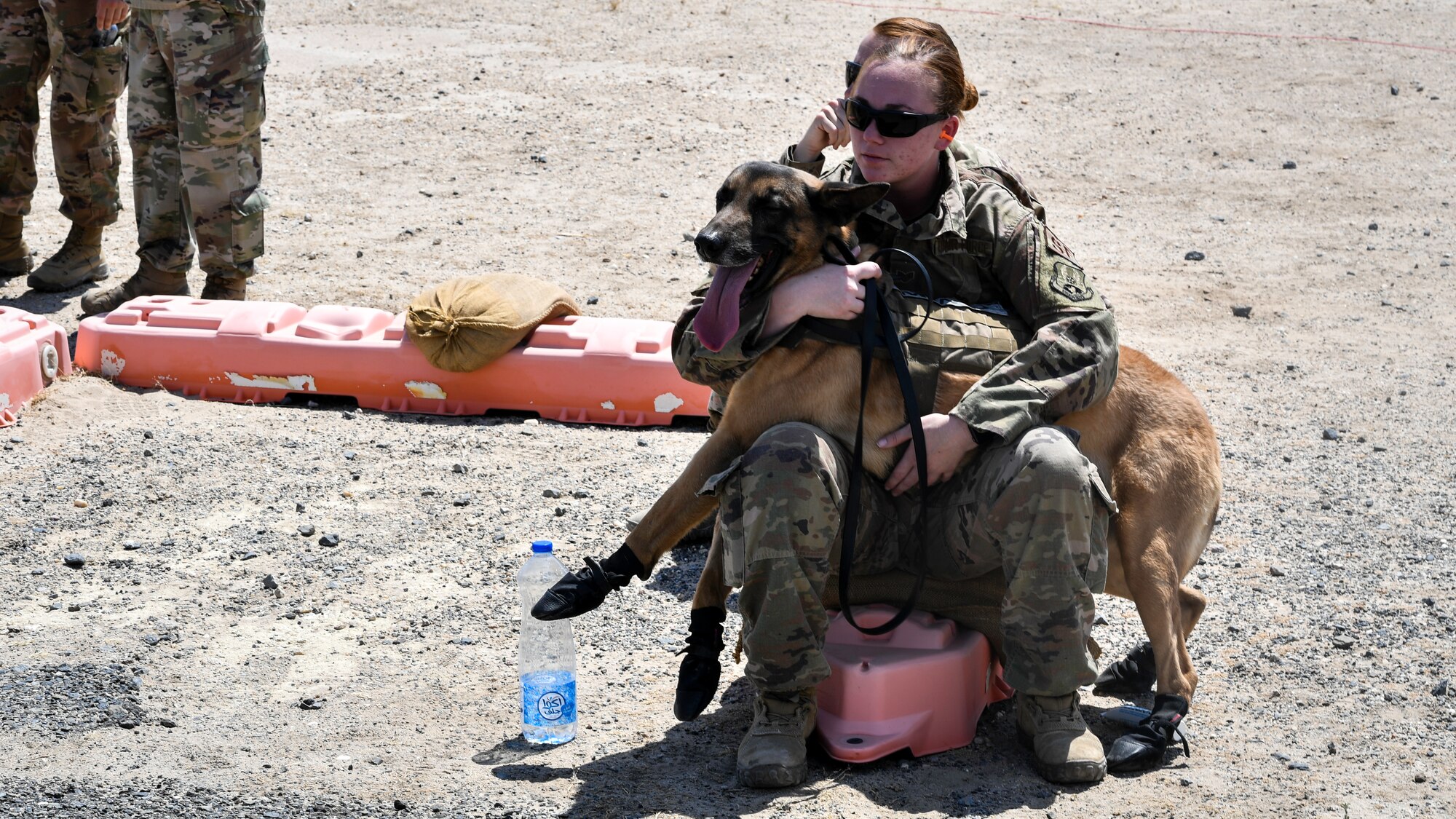 U.S. Air Force Staff Sgt. Christina Hilliary, 407th Expeditionary Security Forces Squadron military working dog handler, takes a break with her MWD during a medical evacuation exercise at Ali Al Salem Air Base, Kuwait, Sept. 13, 2019. The exercise included veterinarian clinical specialist with the 149th Medical Detachment Veterinary Service Support Unit; medical first responders with the 386th Expeditionary Medical Group and more than 15 military working dog teams from various locations around the U.S. Central Command area of responsibility. (U.S. Air Force photo by Staff Sgt. Mozer O. Da Cunha)