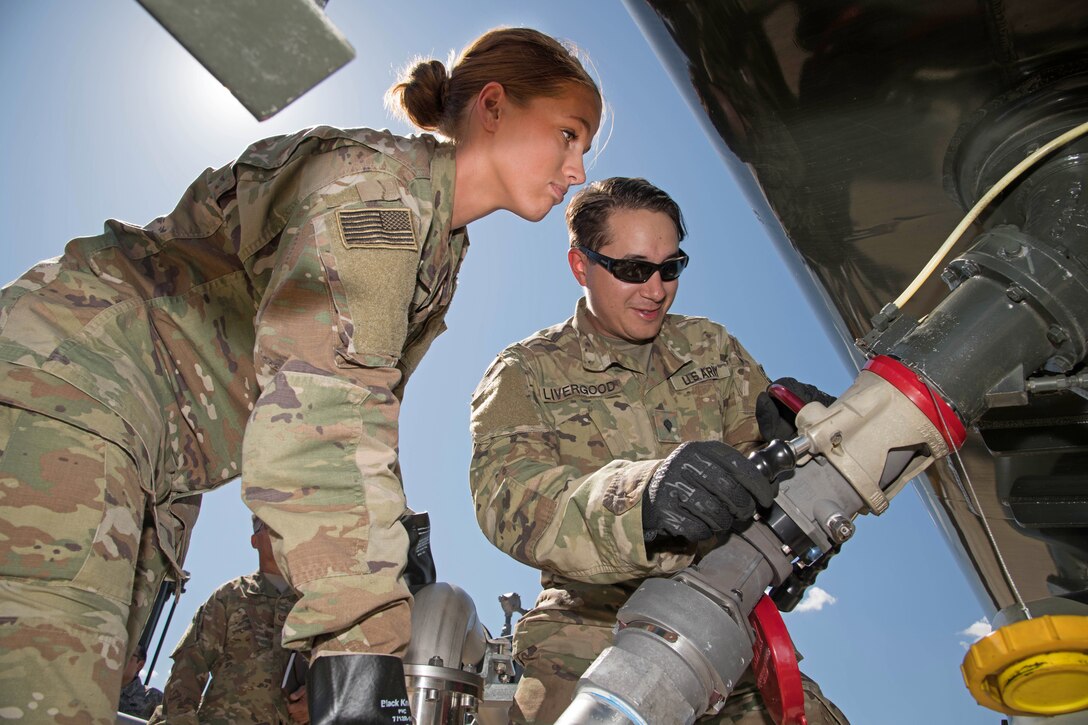 Army Soldiers attach a fuel hose to a truck at Peterson Air Force Base, Colorado, September 6, 2019.