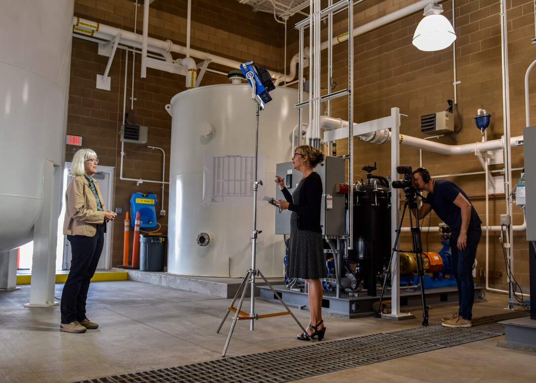 Kathryn Lynnes (left), Bulk Fuels Facility senior program manager, is interviewed by Laura Paskus (middle), New Mexico Public Broadcasting Service correspondent, at Kirtland Air Force Base, N.M., Sept. 16, 2019. PBS filmed a news story at Kirtland’s groundwater treatment facility concerning what has been done to clean up the fuel spill. (U.S. Air Force photo by Airman 1st Class Austin J. Prisbrey)