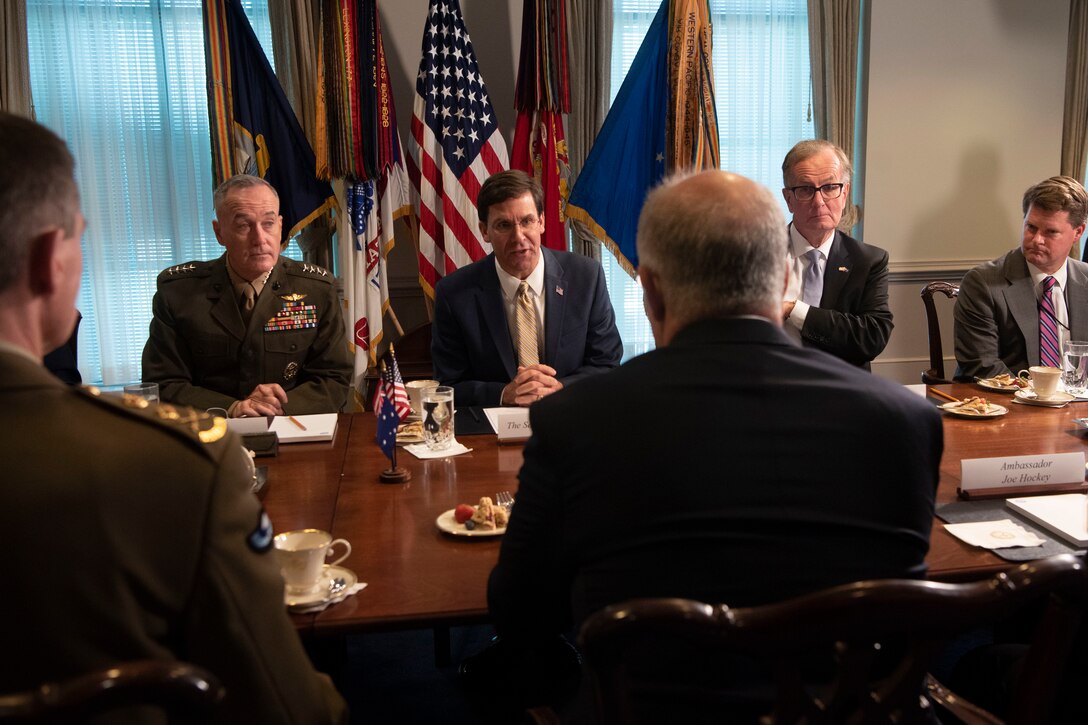 A group of men sitting at a table.