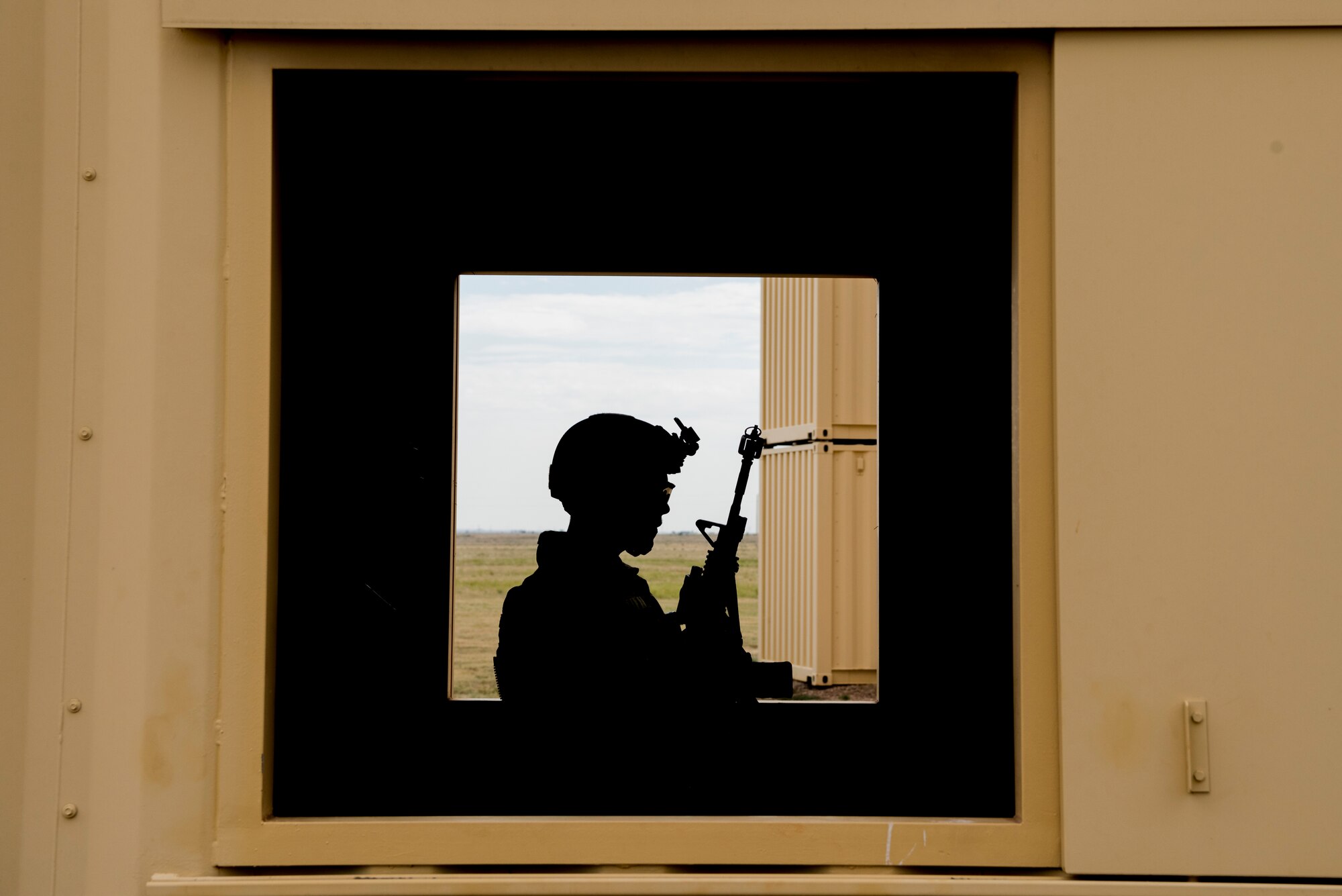 Staff Sgt. Nestor Albalos, 27th Special Operations Security Forces Squadron Deployed Aircraft Ground Response Element team member, relaxes by a window before a scenarios starts during the 2019 Medical Rodeo at Melrose Air Force Range, N.M., Sept. 19, 2019. The Medic Rodeo is designed to test the skills of air force medical technicians in both deployed and home installation environments. (U.S. Air Force photo by Staff Sgt. Michael Washburn)