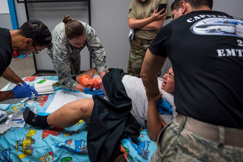 A team of medical technicians perform in an on-scene birth scenario at the Cannon Air Force Base Medic Rodeo, Cannon Air Force Base, N.M., Sept. 17, 2019. The Medic Rodeo is designed to test the skills of Air Force medical technicians in both deployed and home instillation environments. (U.S. Air Force photo by Senior Airman Vernon R. Walter III)