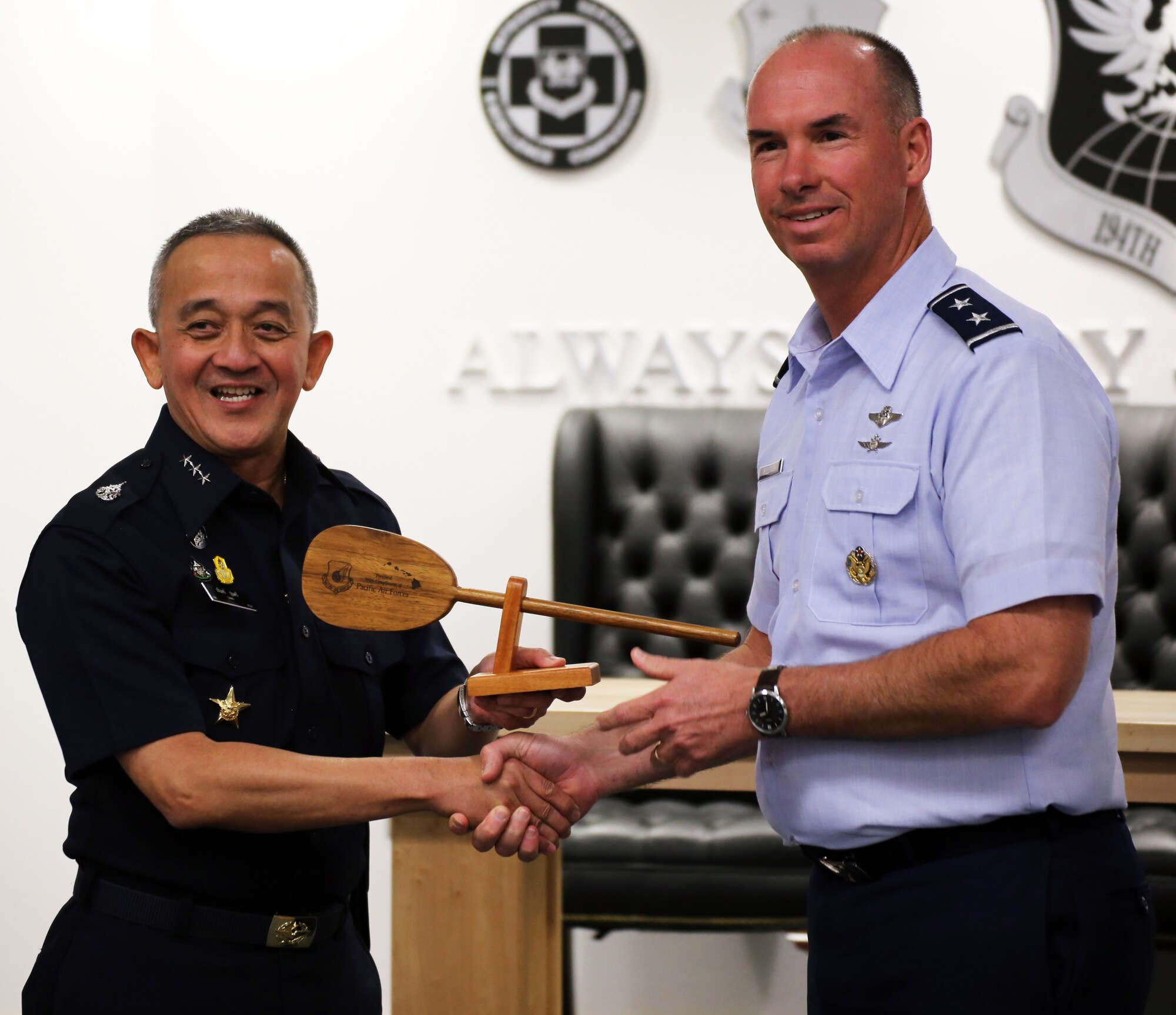 U.S. Air Force Maj. Gen. Brian Killough, Pacific Air Forces deputy commander, presents Air Marshal Tarin Punsri, Royal Thai air force, a gift from Hawaii during the closing ceremonies of the sixth Airman-to-Airman talks at Camp Murray, Wash., Aug. 28, 2019. A2A talks are jointly held conferences between PACAF and regional partner air forces designed to bring together both air forces to discuss and improve on training, tactics and procedures. This year marked the first talks to include participation by the Washington National Guard, with Washington state as the state partner to Thailand since 2002. (U.S. National Guard photo by Joseph Siemandel)