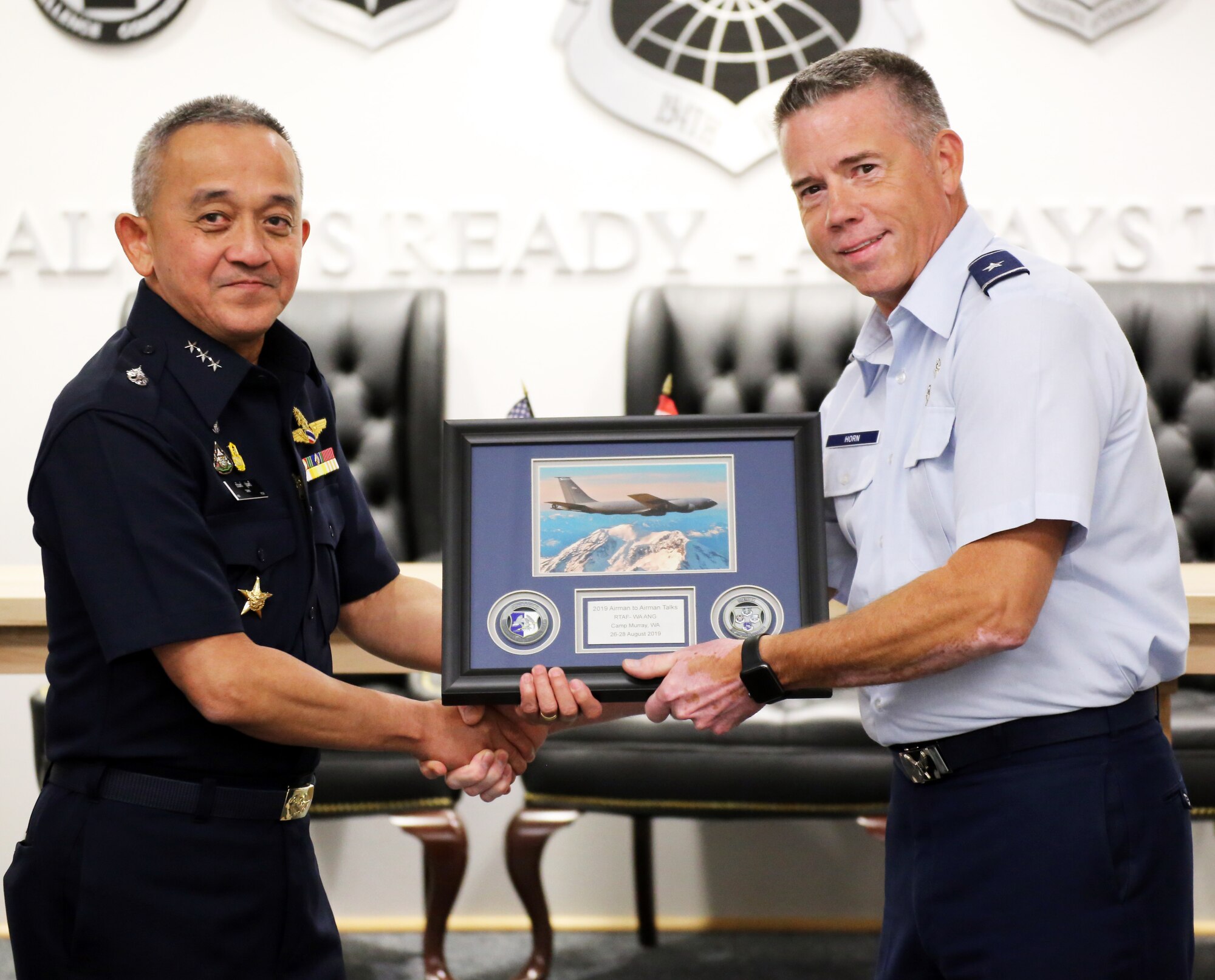 U.S. Air Force Brig. Gen. Jeremy Horn, Washington Air National Guard commander, presents Air Marshal Tarin Punsri, Royal Thai air force, a gift during the closing ceremonies of the sixth Airman-to-Airman talks at Camp Murray, Wash., Aug. 28, 2019.A2A talks are jointly held conferences between PACAF and regional partner air forces designed to bring together both air forces to discuss and improve on training, tactics and procedures. This year marked the first talks to include participation by the Washington National Guard, with Washington state as the state partner to Thailand since 2002. (U.S. National Guard photo by Joseph Siemandel)