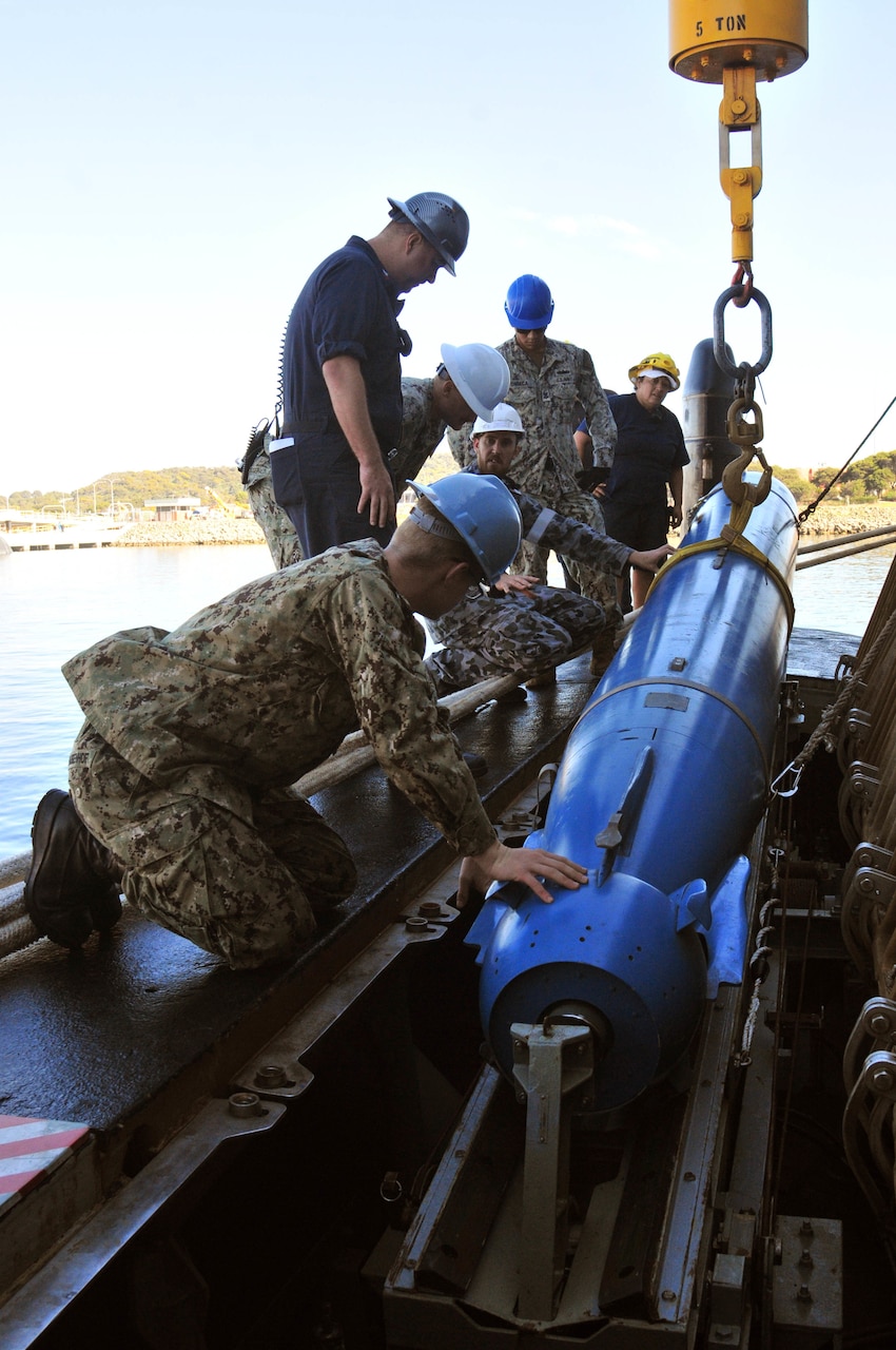 FREMANTLE, Australia (Sept. 13, 2019) - Sailors from the submarine tender USS Emory S. Land (AS 39) and the Australian Collins-class submarine HMAS Sheean (SSG 77) practice receiving an inert training torpedo from Land to Sheean during a bilateral training event Sept. 13. Land is deployed to the U.S. 7th Fleet area of operations to support theater security cooperation efforts in the Indo-Pacific region.