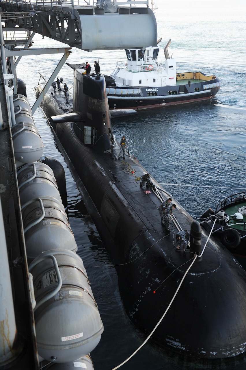 The Australian Collins-class submarine HMAS Sheean (SSG 77) moors alongside the submarine tender USS Emory S. Land (AS 39) during a bilateral training event Sept. 13. Land is deployed to the U.S. 7th Fleet area of operations to support theater security cooperation efforts in the Indo-Pacific region.