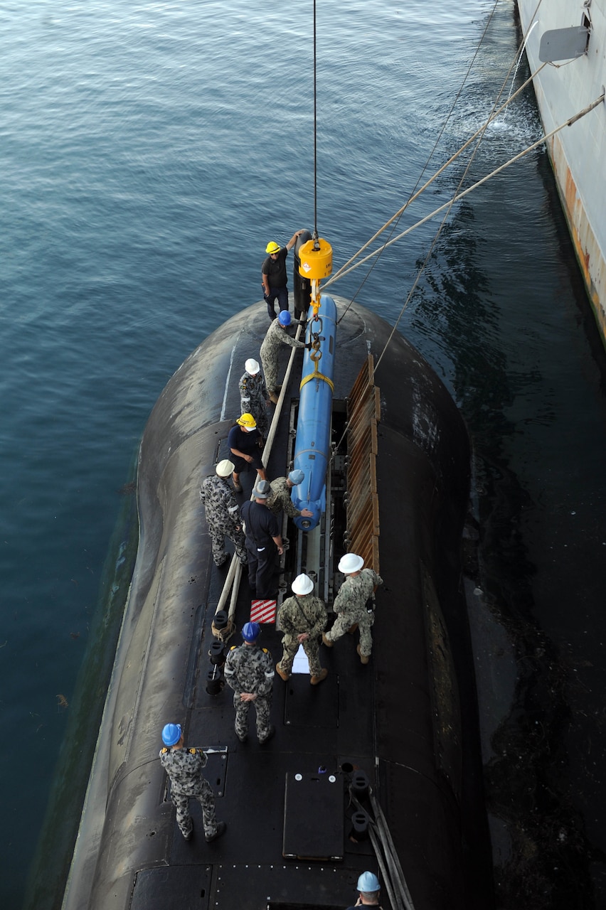 FREMANTLE, Australia (Sept. 13, 2019) - Sailors from the submarine tender USS Emory S. Land (AS 39) and the Australian Collins-class submarine HMAS Sheean (SSG 77) practice receiving an inert training torpedo from Land to Sheean during a bilateral training event Sept. 13. Land is deployed to the U.S. 7th Fleet area of operations to support theater security cooperation efforts in the Indo-Pacific region.