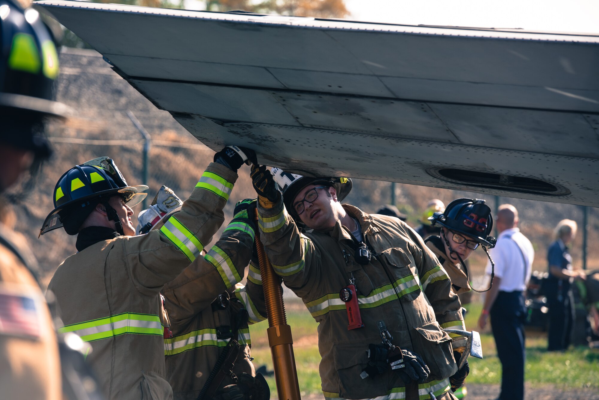 Firefighters from the 193rd Special Operations Civil Engineering Squadron, Cumberland, Dauphin, Lancaster and York counties work to hoist up the wing of a simulated aircraft crash during an exercise held at the September 21, 2019, at Harrisburg International Airport, in Middletown, Pennsylvania.