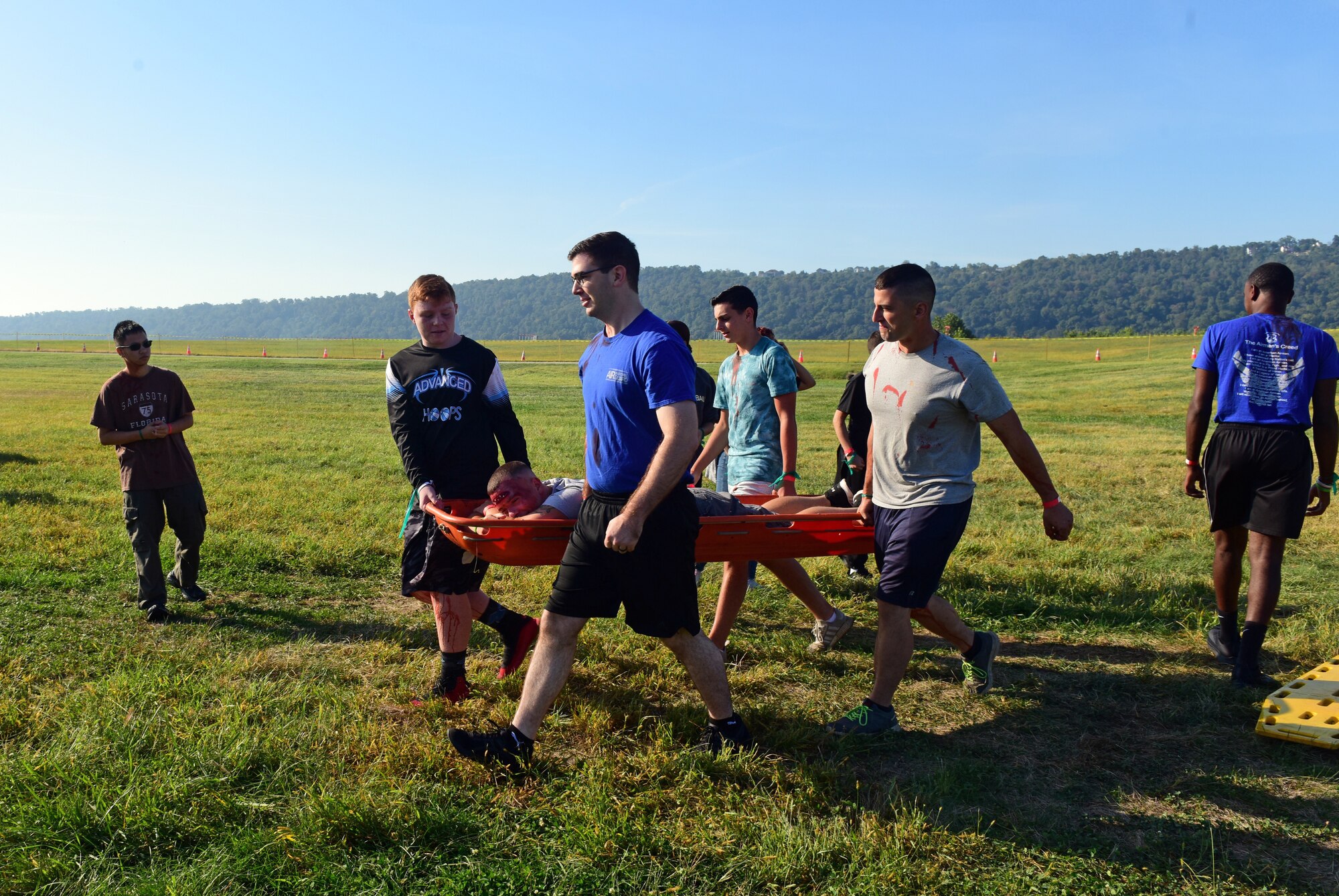 Members of the 193rd Special Operations Wing student flight and local volunteers help to transport the wounded to safety during a simulated aircraft crash exercise held September 21, 2019, at Harrisburg International Airport, in Middletown, Pennsylvania.