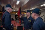 PHILIPPINE SEA (Sept. 20, 2019) Rear Adm. Karl Thomas, commander, Task Force 70, far left, Capt. Steve DeMoss, commander, Destroyer Squadron 15, center, and Cmdr. Jennifer Bowden, USS Ronald Reagan chaplain, salute during a Destroyer Squadron (DESRON) 15 change of command ceremony aboard the forward-deployed aircraft carrier USS Ronald Reagan (CVN 76). DESRON 15 is the Navy's largest forward-deployed DESRON and the U.S. 7th Fleet's principal surface force.