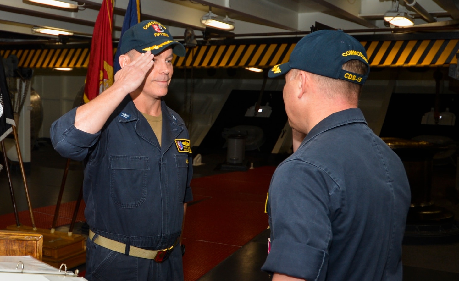 Capt. Steven DeMoss, left, relieves Capt. Jon Duffy as commander, Destroyer Squadron (DESRON) 15 during the DESRON 15 change of command ceremony aboard the aircraft carrier USS Ronald Reagan (CVN 76). DESRON 15 is the Navy's largest forward-deployed DESRON and the U.S. 7th Fleet's principal surface force.