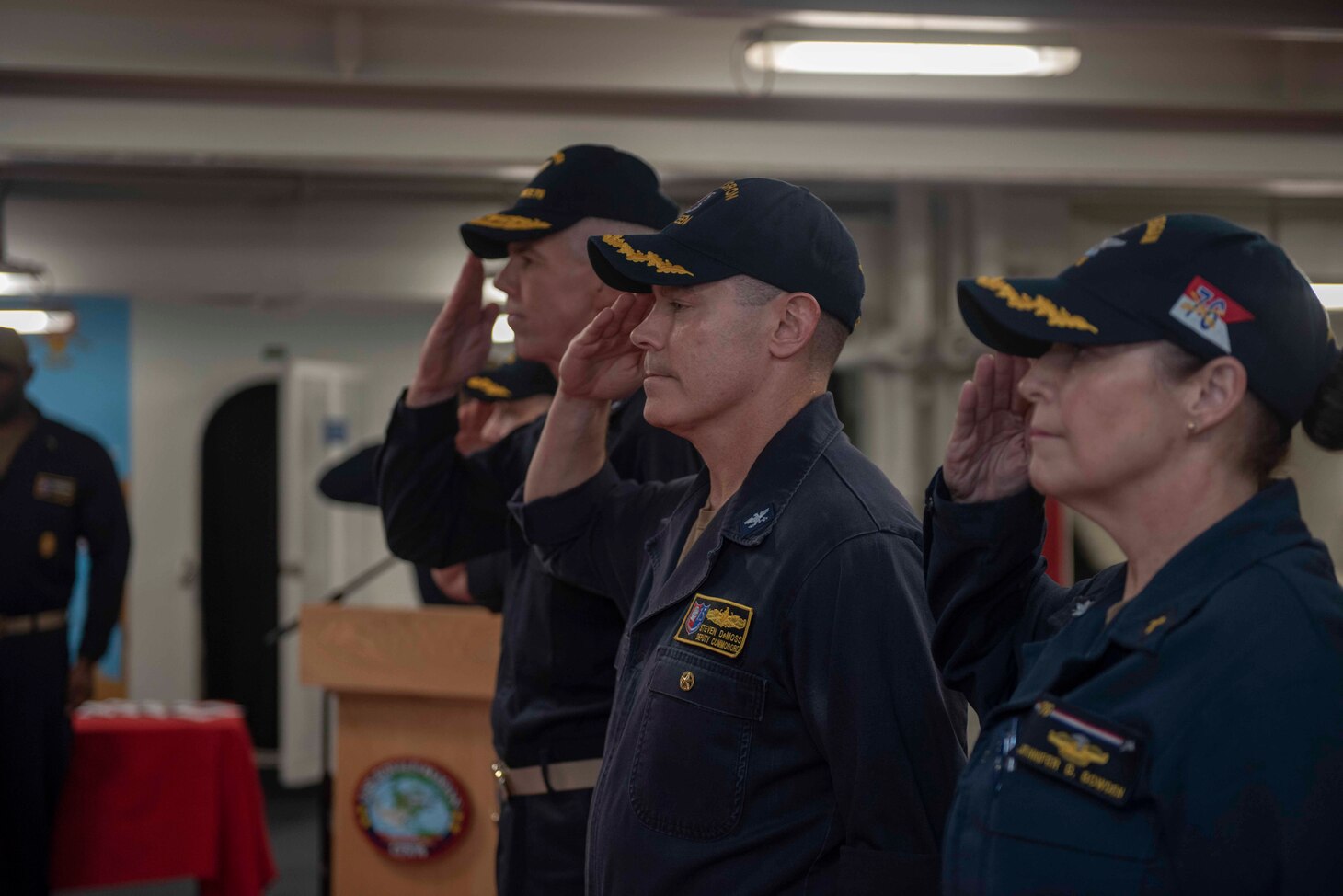 Capt. Steven DeMoss, commander, Destroyer Squadron (DESRON) 15, center, notifies Rear Adm. Karl Thomas, commander, Task Force 70, that he properly relieved Capt. Jon Duffy, off-going commander, DESRON 15, during the DESRON 15 change of command ceremony aboard the aircraft carrier USS Ronald Reagan (CVN 76). DESRON 15 is the Navy's largest forward-deployed DESRON and the U.S. 7th Fleet's principal surface force.