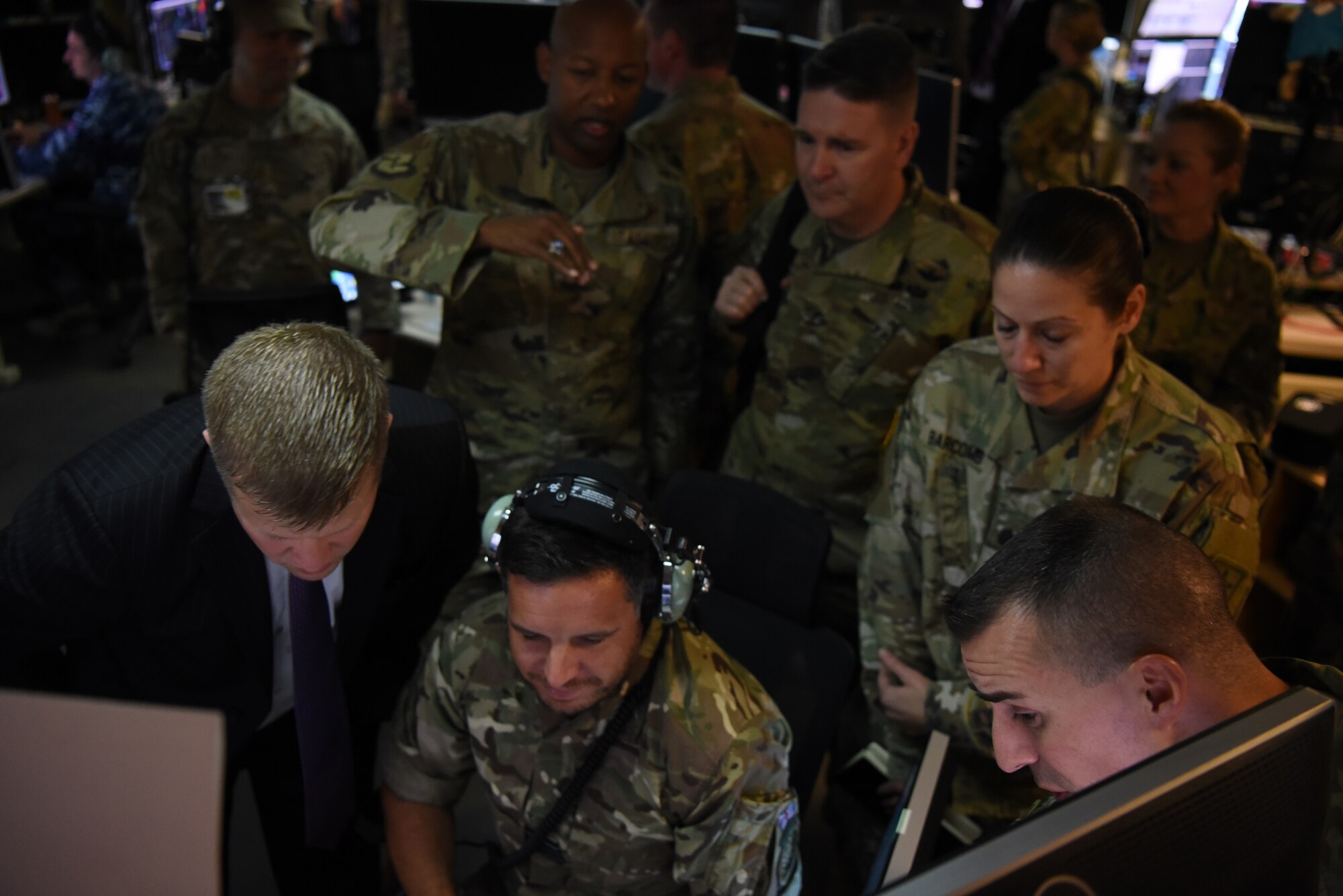 Ryan D. McCarthy, acting Secretary of the Army, is briefed by Squadron Leader David Scott, Royal Air Force mission crew commander and RAF contingency commander, on the floor of the 727th Expeditionary Air Control Squadron Sept. 20, 2019, on Al Dhafra Air Base, United Arab Emirates.