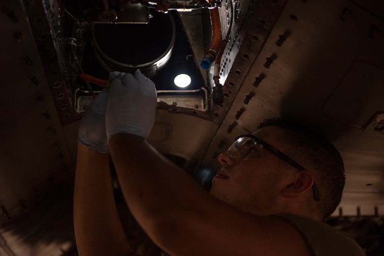 U.S. Air Force Senior Airman Dylan Bittle, 18th Equipment Maintenance Squadron phase inspector, installs a jet-fuel starter during a phase inspection at Kadena Air Base, Japan, Sept. 17, 2019.