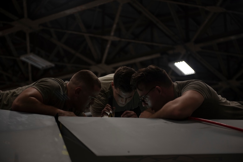 U.S. Airmen assigned to the 18th Equipment Maintenance Squadron inspect an F-15C Eagle during a phase inspection at Kadena Air Base, Japan, Sept. 17, 2019.
