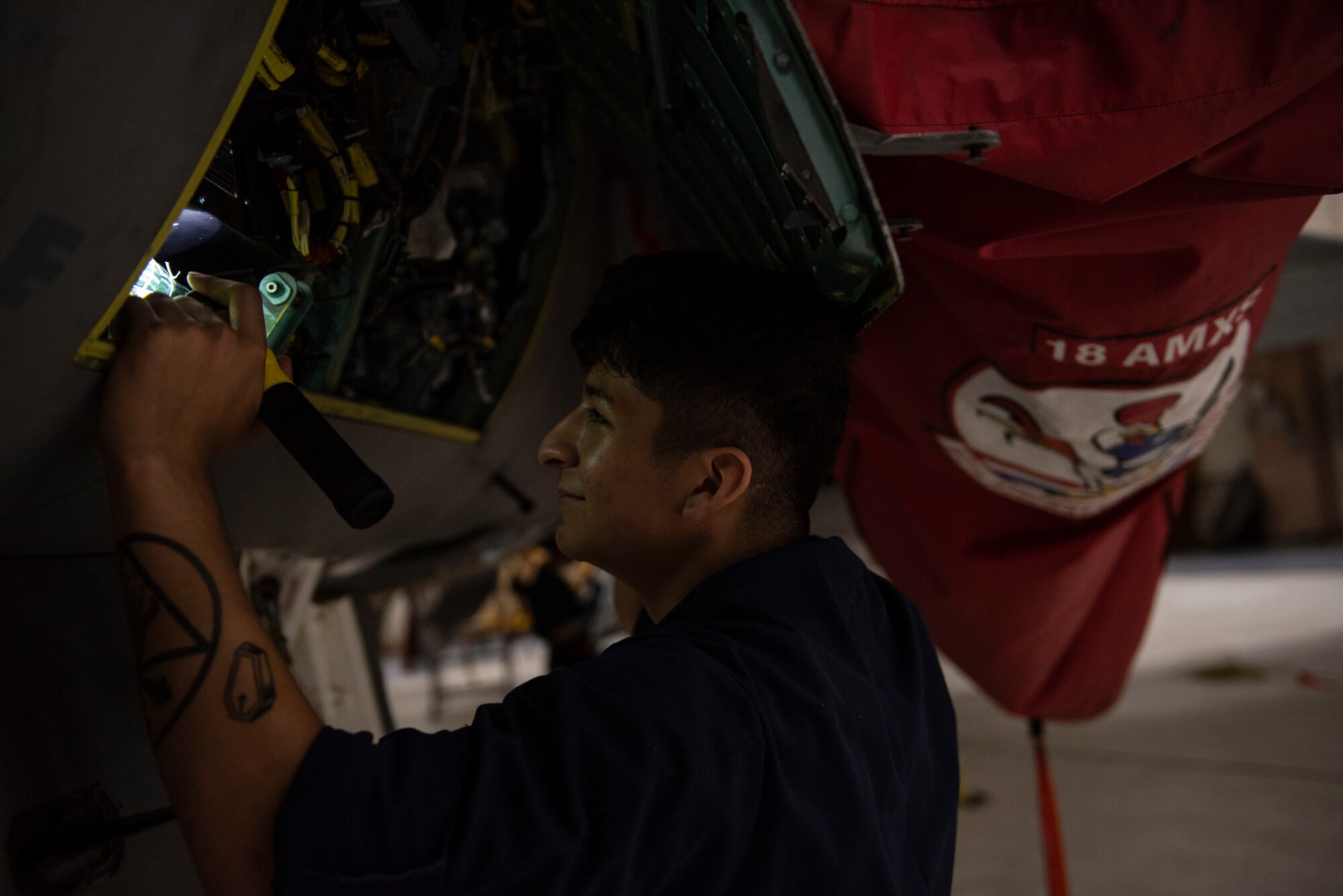 U.S. Air Force Airman 1st Class Victor Luna-Pena, 18th Equipment Maintenance Squadron phase inspector, examines an F-15C Eagle during a phase inspection at Kadena Air Base, Japan, Sept. 17, 2019.