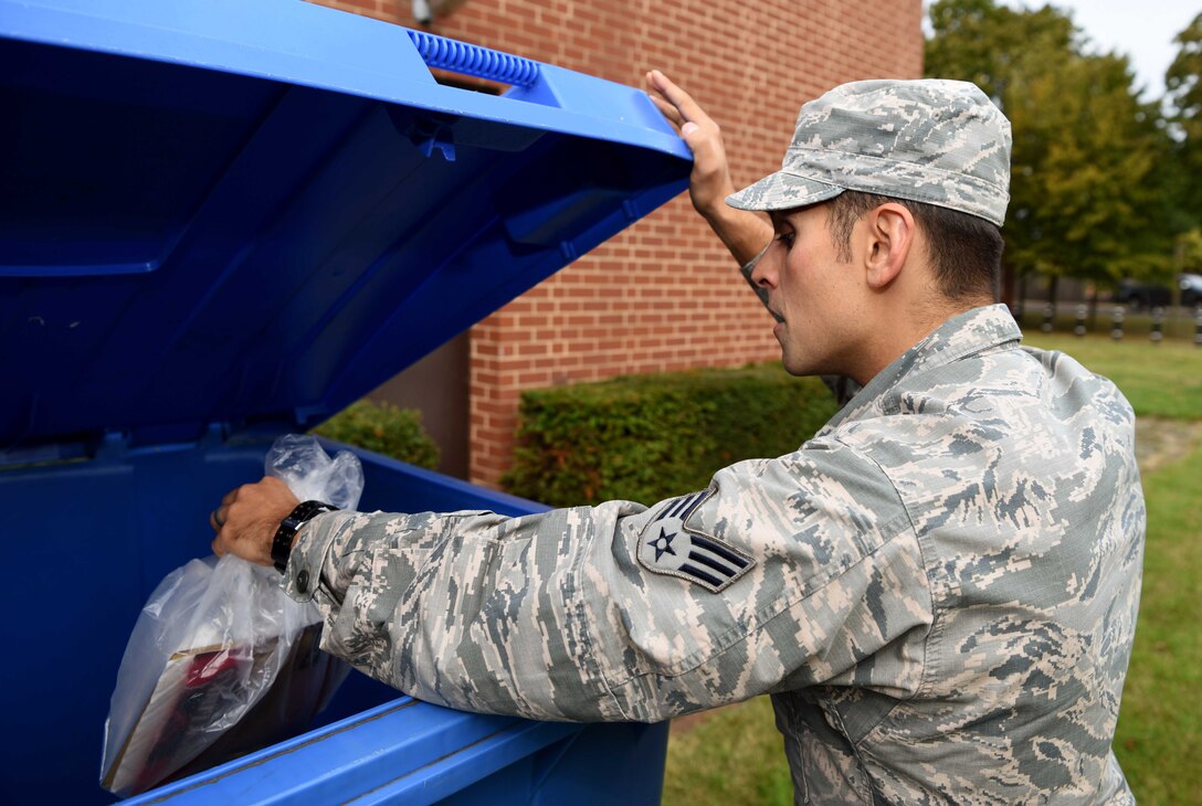 Senior Airman Luke Milano, 100th Air Refueling Wing photojournalist, disposes of waste in one of the external bins provided by the 100th Civil Engineer Squadron Recycling Center at RAF Mildenhall, England, Sept. 11, 2019. The recycling center provides external bins, labels, collect, transport and processes materials in the hopes of diverting waste from landfills. In fiscal year 2019, RAF Mildenhall is on pace to separate approximately 450 tons of waste for recycling which will generate about $40,000 for base projects. (U.S. Air Force photo by Airman 1st Class Brandon Esau)