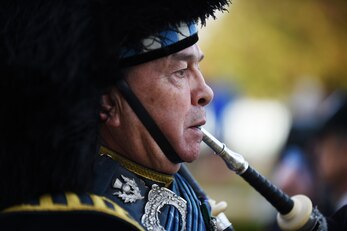 Royal Air Force Warrant Officer, retired, Gary Kernaghan plays a bagpipe during a Veterans Day ceremony at Cambridge American Cemetery, United Kingdom, Nov. 11, 2015. Since 1919, the United States has set aside the 11th day of November to remember the sacrifices of veterans both past and present. (U.S. Air Force photo by Staff Sgt. Jarad A. Denton)