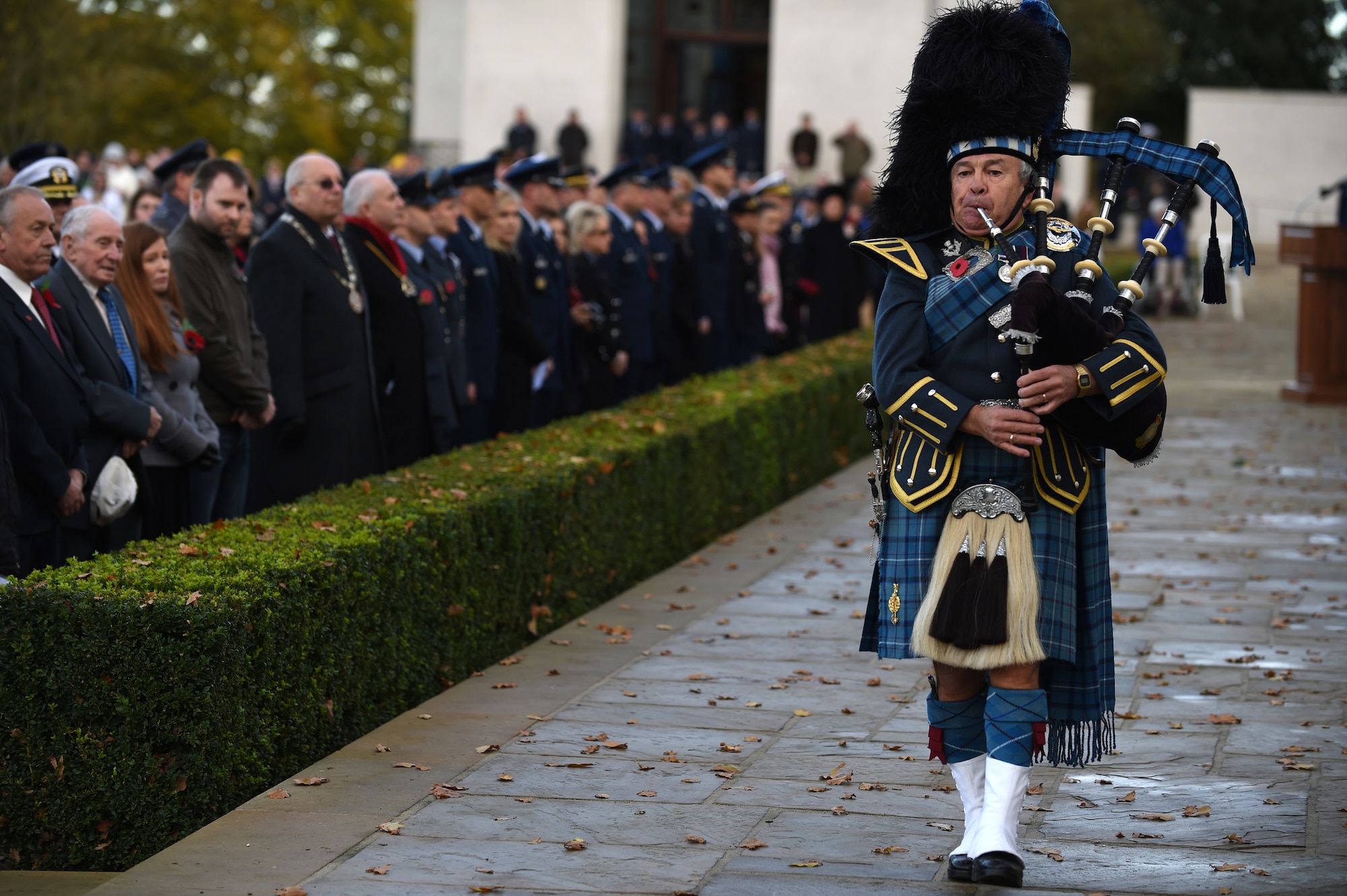 Royal Air Force Warrant Officer, retired, Gary Kernaghan plays the bagpipes during a Veterans Day ceremony at Cambridge American Cemetery, United Kingdom, Nov. 11, 2014. Since 1919, the United States has set aside the 11th day of November to remember the sacrifices of veterans both past and present. (U.S. Air Force photo by Staff Sgt. Jarad A. Denton)