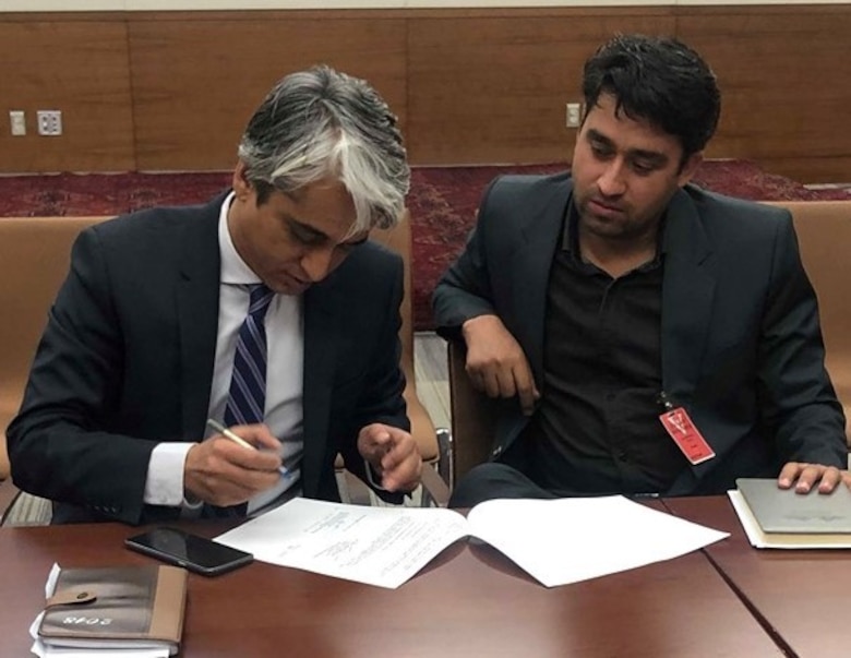 Representatives of the Afghanistan Ministry of Energy and Water sign the turnover papers of the SEPS Sangin to Lashkar Gah Transmission Line Project.