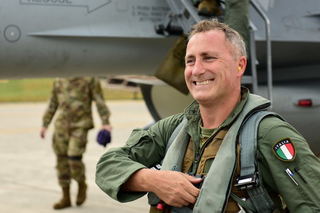 Italian air force Col. Vincenzo Tozzi, Aviano base commander, greets friends and family after exiting an F-16 Fighting Falcon at Aviano Air Base, Italy, Sept. 17, 2019. Col. Tozzi was given a flight in an F-16 as a show of gratitude from the 31st Fighter Wing for his time as base commander. (U.S. Air Force photo by Staff Sgt. Kelsey Tucker)