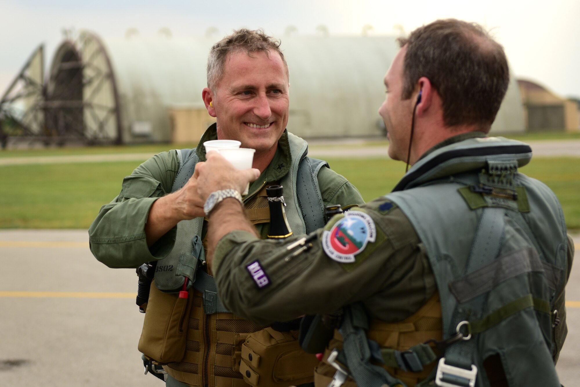Italian air force Col. Vincenzo Tozzi, Aviano base commander, left, and U.S. Air Force Lt. Col. Daniel Lindsey, commander of the 510th Fighter Squadron, share a toast at Aviano Air Base, Italy, Sept. 17, 2019. Col. Tozzi was Lt. Col. Lindsey’s instructor pilot while they were at Sheppard Air Force Base, Texas, 16 years ago. (U.S. Air Force photo by Staff Sgt. Kelsey Tucker)