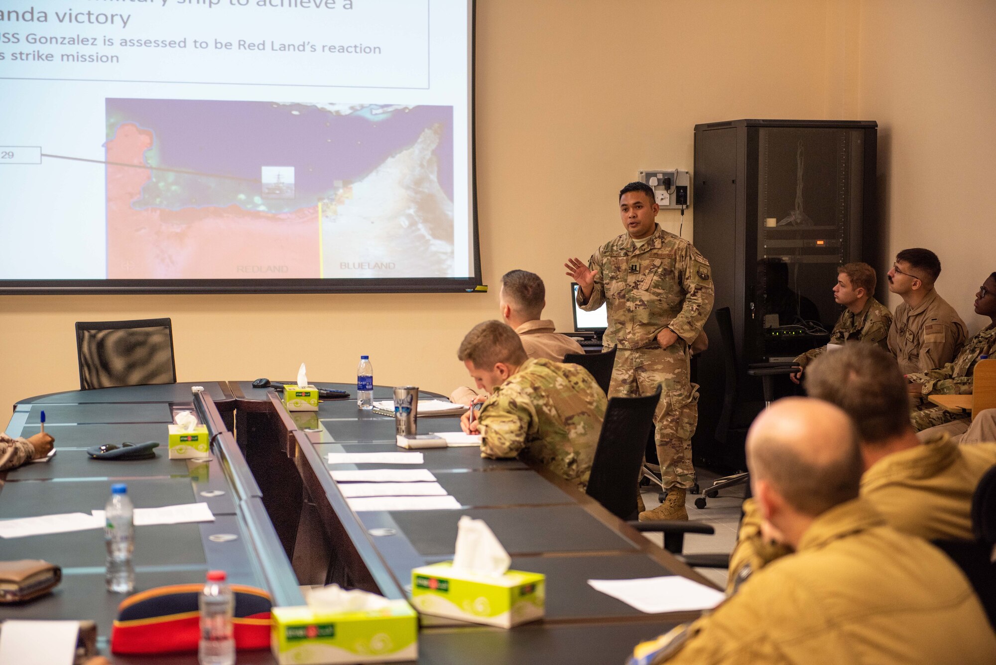 Capt. Patterson Aldueza, U.S. Air Forces Central Command AWC intelligence branch officer, briefs mission planning during a large force exercise Aug. 27, 2019, United Arab Emirates. The exercise brought French, Emirati and American forces together to build partnerships, tactical capabilities and interoperability with allies. (U.S. Air Force photo by Staff Sgt. Chris Thornbury)