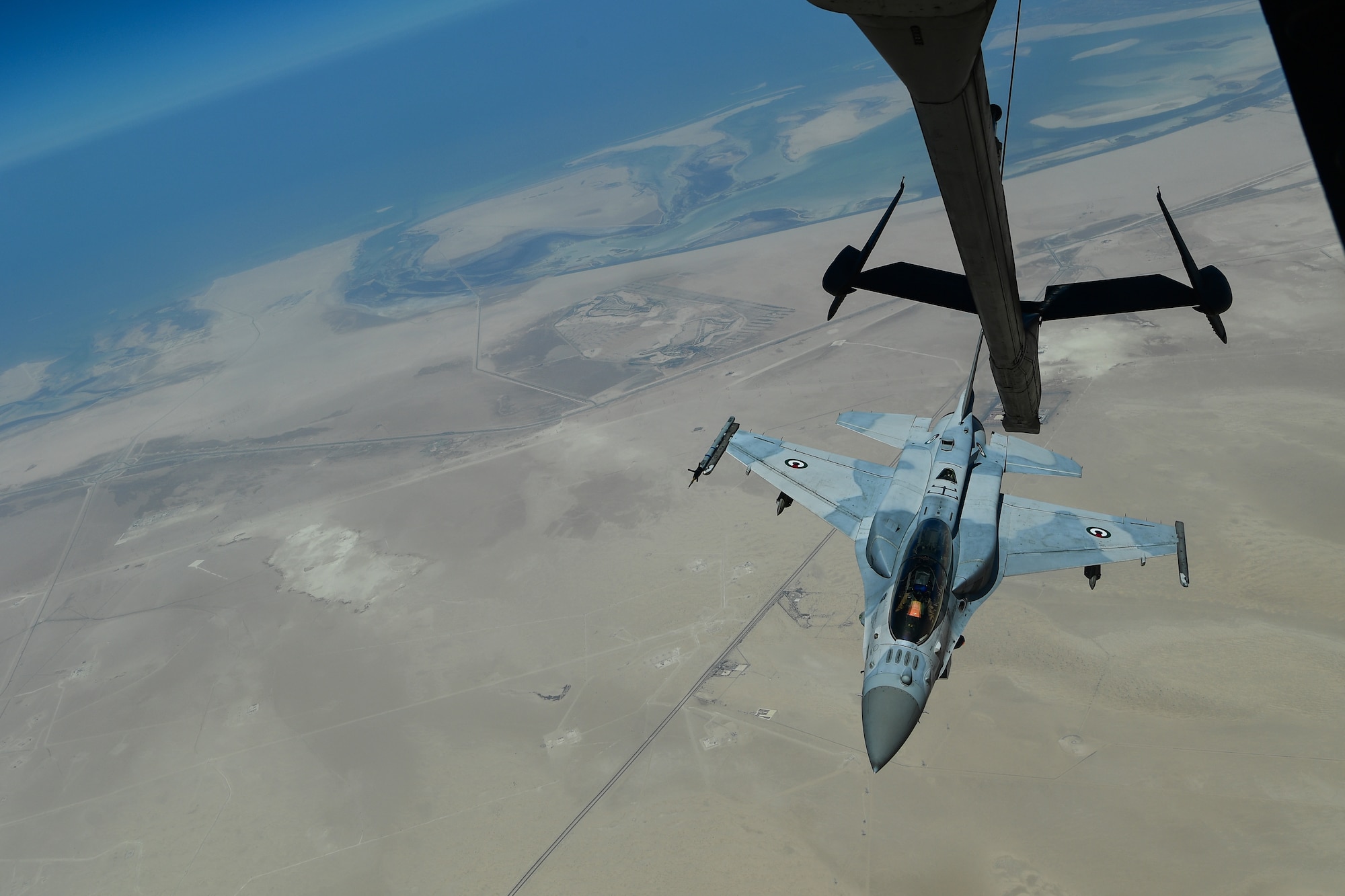 A United Arab Emirates F-16 Desert Falcon prepares to connect with a KC-10 Extender assigned to the 908th Expeditionary Air Refueling Squadron out of Al Dhafra Air Base, United Arab Emirates, Aug. 28, 2019. The UAE F-16 pilot partnered with the U.S. asset to maintain proficiency in aerial coupling. (U.S. Air Force photo by Staff Sgt. Chris Drzazgowski)